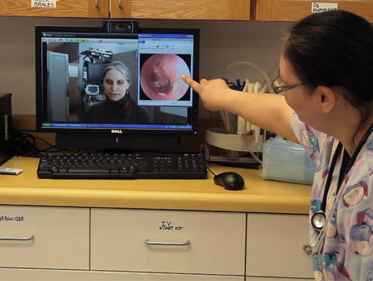 Nurse diagnosing patient remotely through Vidyo Nurse diagnosing patient remotely through Vidyo