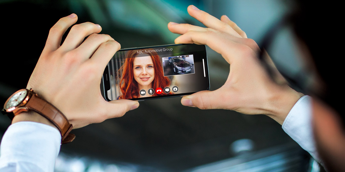 virtual car dealership a man holding phone showing car to a female