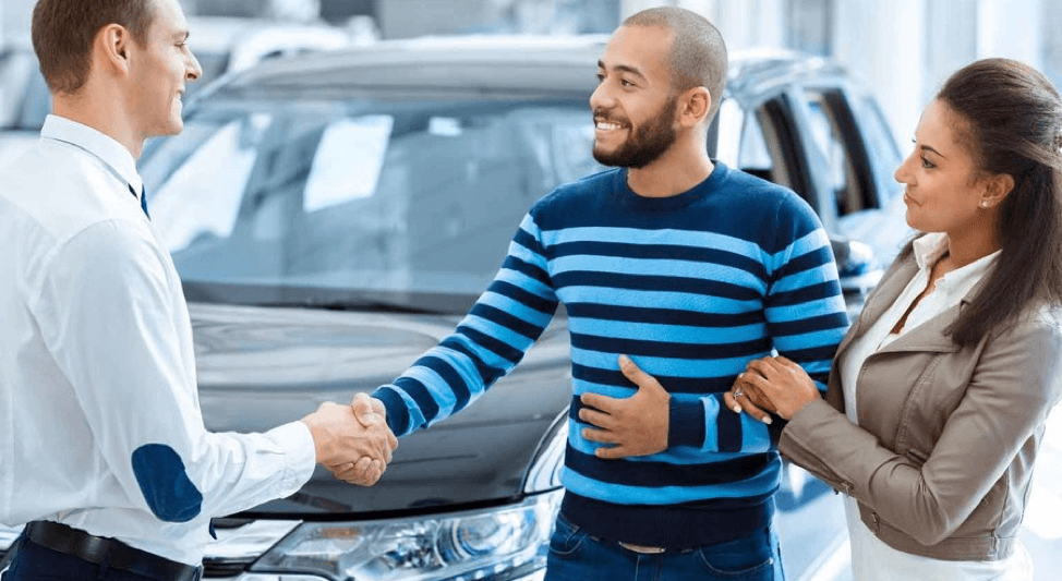 car dealer shaking hands with couple car dealer shaking hands with couple