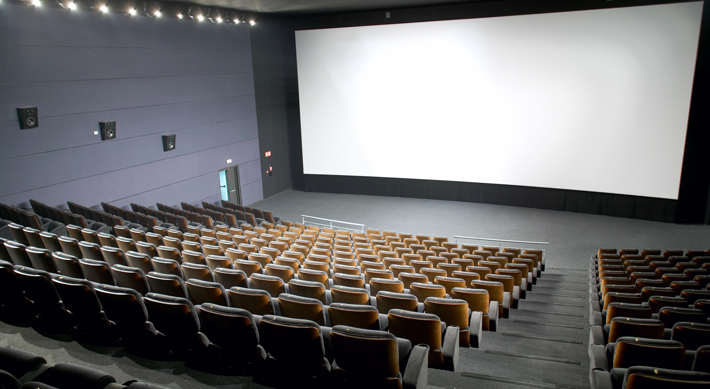 Modern cinema interior with seats and screen People Using Mobile Devices